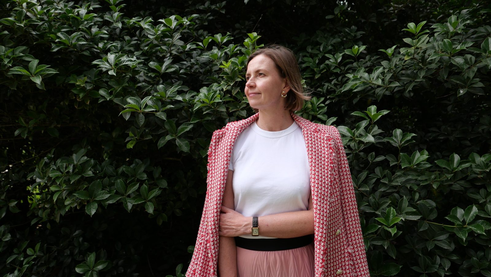 Zantelle van der Linde, founder of NEON NAVY, outdoors in a pink jacket